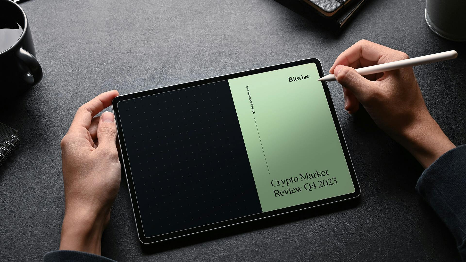 person holding ipad with pdf quarterly report pdf